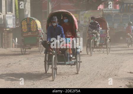 Dhaka, Bangladesh - November 28, 2020: The dusty blanket of the ongoing development work for Dhaka-Mawa Highway. People at Keraniganj in Dhaka have lo Stock Photo