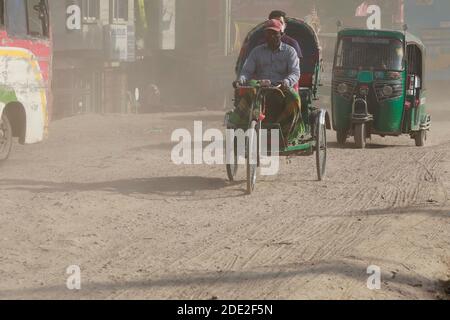 Dhaka, Bangladesh - November 28, 2020: The dusty blanket of the ongoing development work for Dhaka-Mawa Highway. People at Keraniganj in Dhaka have lo Stock Photo