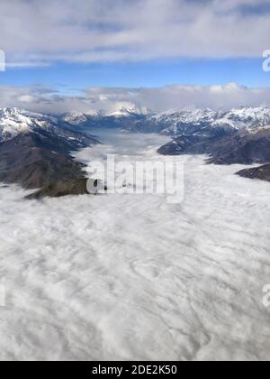 Aerial view of the Italian Alps Mountain tops emerging above the clouds. In the center: the Sacra di San Michele medieval abbey, the symbol of Piedmon Stock Photo