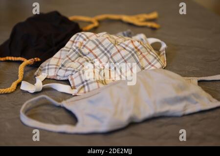 Corona Pandemic: Different Facemasks lying on a table Stock Photo