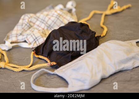 Corona Pandemic: Different Facemasks lying on a table Stock Photo