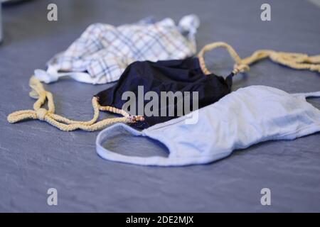 Corona Pandemic: Different Facemasks lying on a table Stock Photo