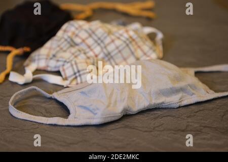 Corona Pandemic: Different Facemasks lying on a table Stock Photo