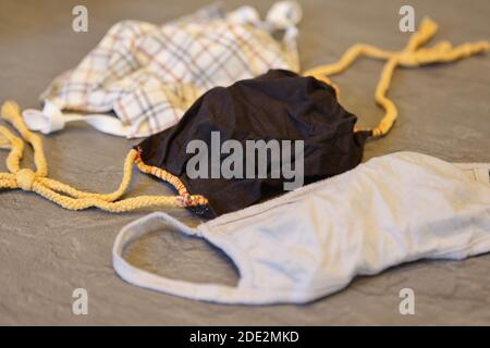 Corona Pandemic: Different Facemasks lying on a table Stock Photo