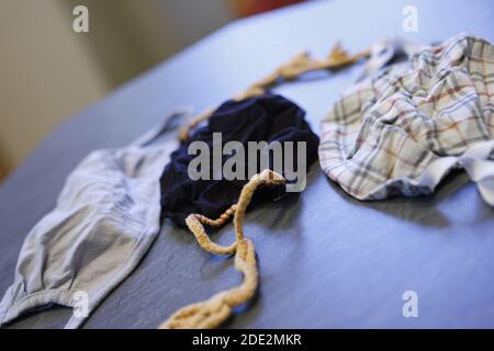 Corona Pandemic: Different Facemasks lying on a table Stock Photo