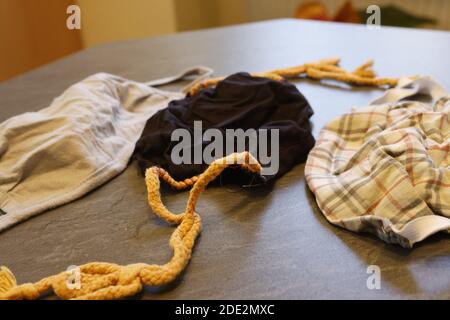 Corona Pandemic: Different Facemasks lying on a table Stock Photo