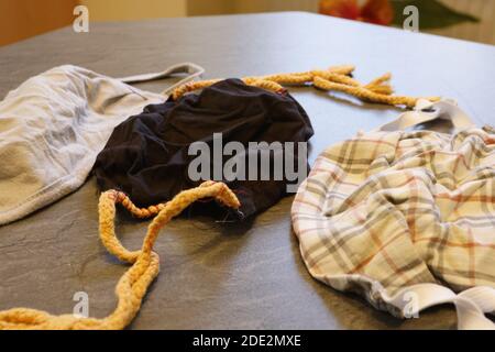 Corona Pandemic: Different Facemasks lying on a table Stock Photo