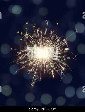 Glittering burning sparkler on dark background with bokeh lights Stock Photo