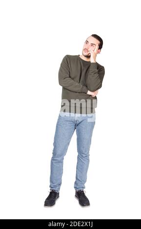 Full length portrait pensive young man, keeps fingers to temple, thoughtful gesture, isolated on white background with copy space. Puzzled casual guy, Stock Photo