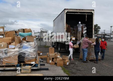 Honduran volunteers unload humanitarian aid for victims of Hurricane Iota delivered by the U.S. Navy November 24, 2020 in Soto Cano Air Base, Honduras. Hurricane Iota swept through Central America destroying large sections of the coast and flooding roads. Stock Photo