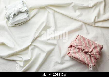 Eco-friendly gift wrap in traditional japanese furoshiki style on fabric background, eco-friendly gift wrap and Zero Wast concept