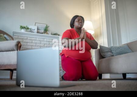Plus size african american woman having an online workout Stock Photo
