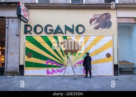 Glasgow, Scotland, UK. 28th November, 2020. Glasgow based illustrator and designer Calum Lockerbie  at work on a new mural on the outside of the famous Rogano restaurant. Credit: Skully/Alamy Live News Stock Photo