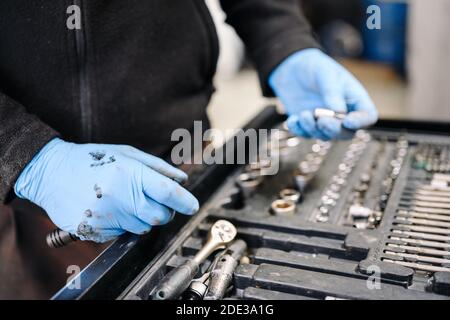A set of tools for repair in car service - mechanic's hands, close up. High quality photo Stock Photo