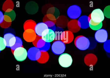 Blurry colored lights of garlands. A horizontal arrangement of a beautiful Christmas and New Year background. Copy space. Stock Photo
