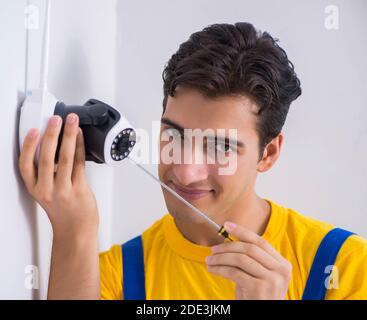 The contractor installing surveillance cctv cameras in office Stock Photo