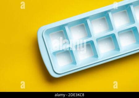 Blue plastic mold for making ice cubes for use in cocktails. Space for text. Top view. Stock Photo