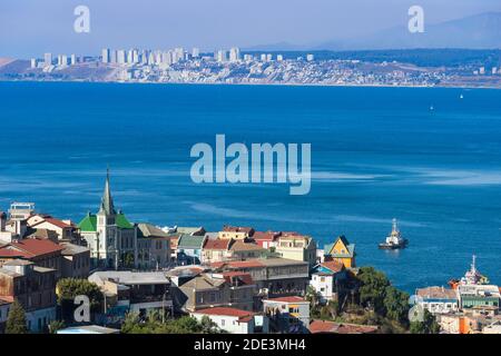 View of Valparaiso and Lutheran Church of the Holy Cross with Vina del Mar in the background, UNESCO, Valparaiso, Valparaiso Region, Chile Stock Photo