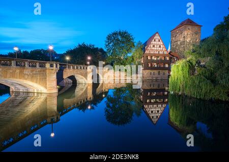 Maxbrücke bridge, Henkerhaus Museum and Weinstadel reflecting in Pegnitz river at twilight, Nuremberg, Germany Stock Photo