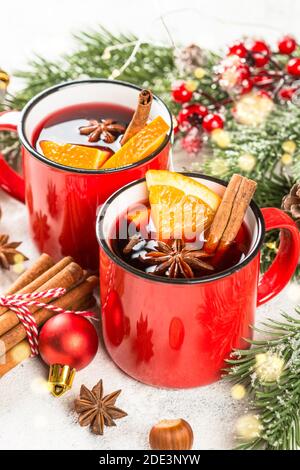 Mulled wine in red mugs with christmas decorations. Stock Photo