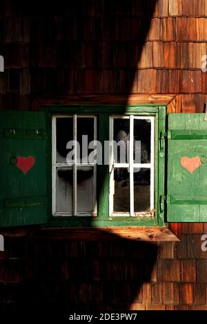 red hearts painted on wooden shutters Stock Photo