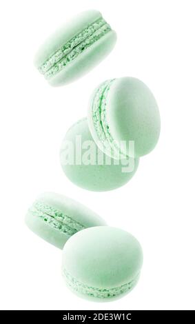 Isolated green macaroons. Five mint or pistachio macaroons falling down over white background Stock Photo