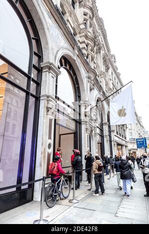 28 November 2020 - London, UK, A queue of people outside the Apple Store on Regent Street at Black Friday weekend duting coronavirus lockdown Stock Photo