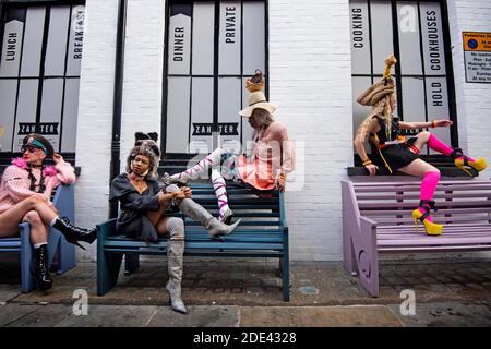Models pose as they showcase clothes by fashion designer Pierre Garroudi during a flashmob fashion shoot on Carnaby Street, London.