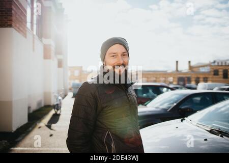 smiling bearded man dressed in winter clothes Stock Photo