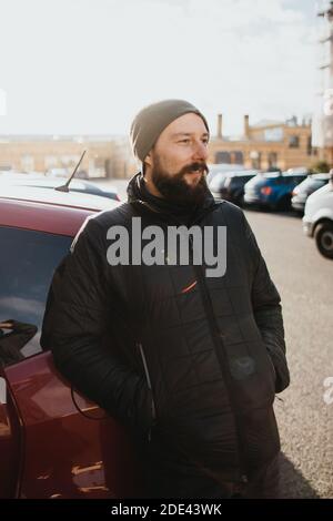 smiling bearded man dressed in winter clothes Stock Photo