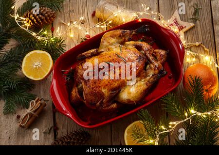 Roasted chicken on wooden rustic table for Christmas dinner Stock Photo