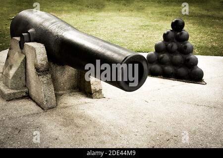 A Civil war era cannon exhibit along with a stack of cannon balls,  a historical display in St. Augustine, FL, Stock Photo