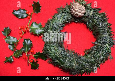 Making Christmas wreath is cheap upon gathering winter seasonal foliage Wreaths are made from evergreen tree branches adorn wall door hang over mantel Stock Photo