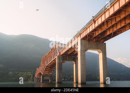 Big Orange Bridge in Nelson, B.C. catches some golden light at the end of the day. Stock Photo