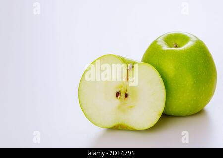 Green cut apple and isolated on white background. Produce product. Stock Photo