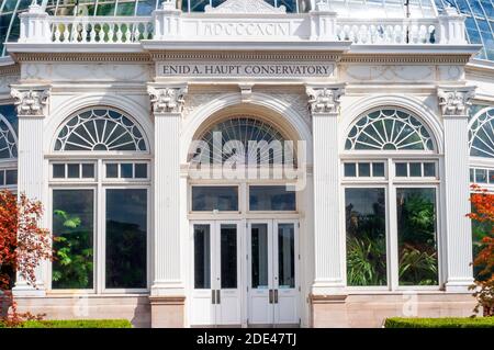 Enid A. Haupt Conservatory and pond with water lilies Greenhouse, New York Botanical Garden, Bronx, New York City, New York State, USA. Stock Photo