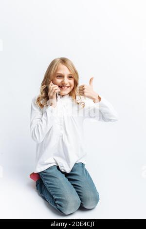 Beautiful teen girl talking on mobile phone, happy about that, photo Studio Stock Photo