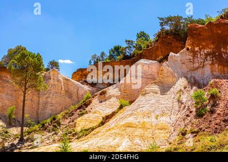 White and red shining ochre rocks, above blue sky, Colorado Provencal nature park Park, Rustrel, Luberon, Provence Stock Photo