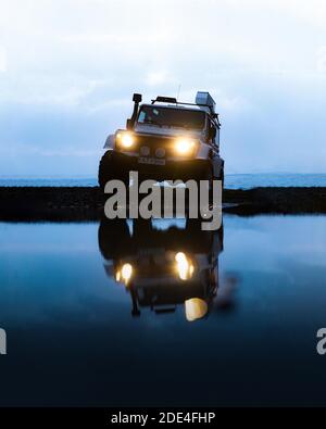 White Land Rover Jeep with reflection in the Blue Hour, Vatnajoekull glacier, Iceland Stock Photo