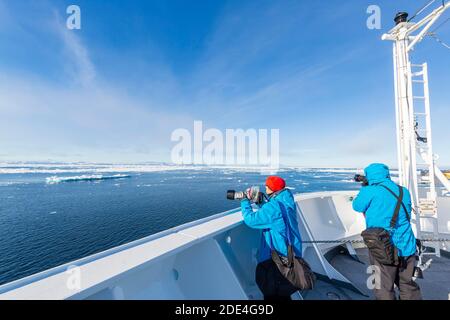 Passengers on deck of a cruise ship, icebergs, sea, east coast Greenland, Denmark Stock Photo