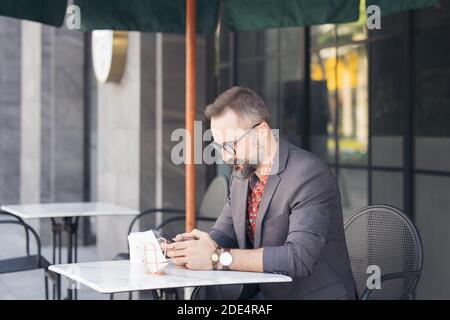 A handsome young man on the terrace, Businessman using a digital game Stock Photo