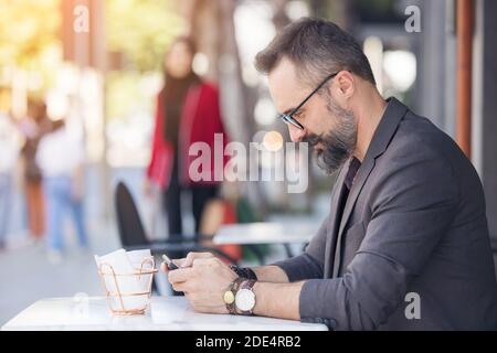 A handsome young man on the terrace, Businessman using a digital game Stock Photo