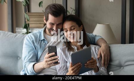 Banner view of happy couple using gadgets Stock Photo
