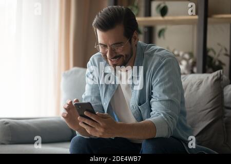 Happy young man use smartphone browsing internet Stock Photo