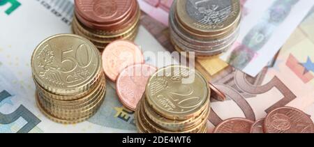 Banknotes and small change on a table Stock Photo