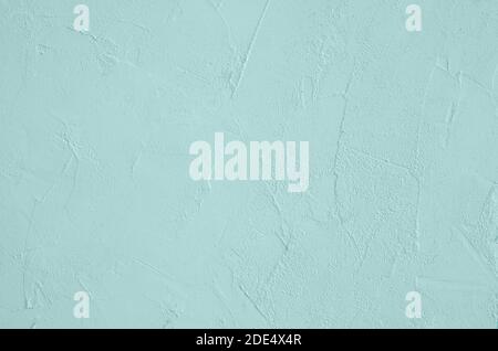 The surface of the plaster is a trendy color of tidewater green. Horizontal orientation, selective focus. Stock Photo
