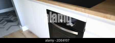 An oven is installed in kitchen furniture apartment Stock Photo