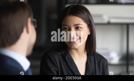 Glad mixed race businesswoman welcoming new staff member in office Stock Photo