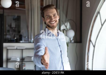 Happy male hr stretching hand inviting you to join team Stock Photo