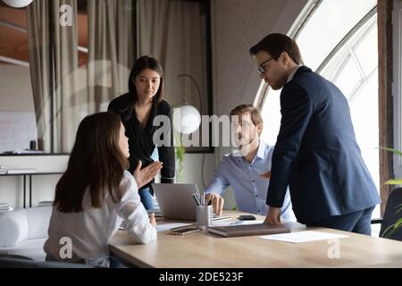 Multicultural millennial colleagues having talk discussion on formal meeting Stock Photo